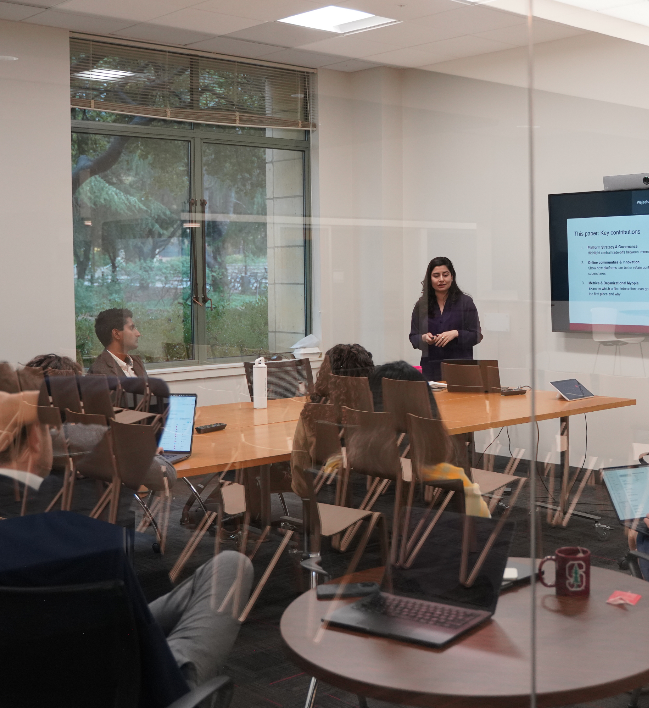 Internal group meeting with person presenting at the front of the group